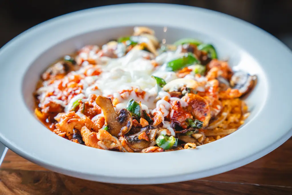 Chicken with mushrooms, peppers and melted cheese