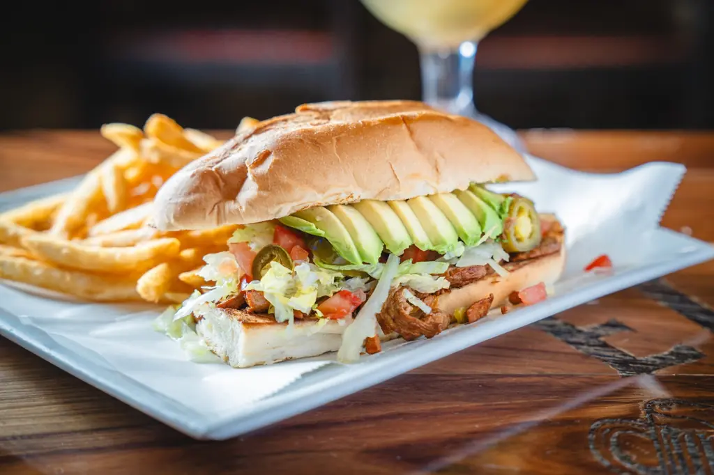 A torta with avocado and jalapenos, with fries